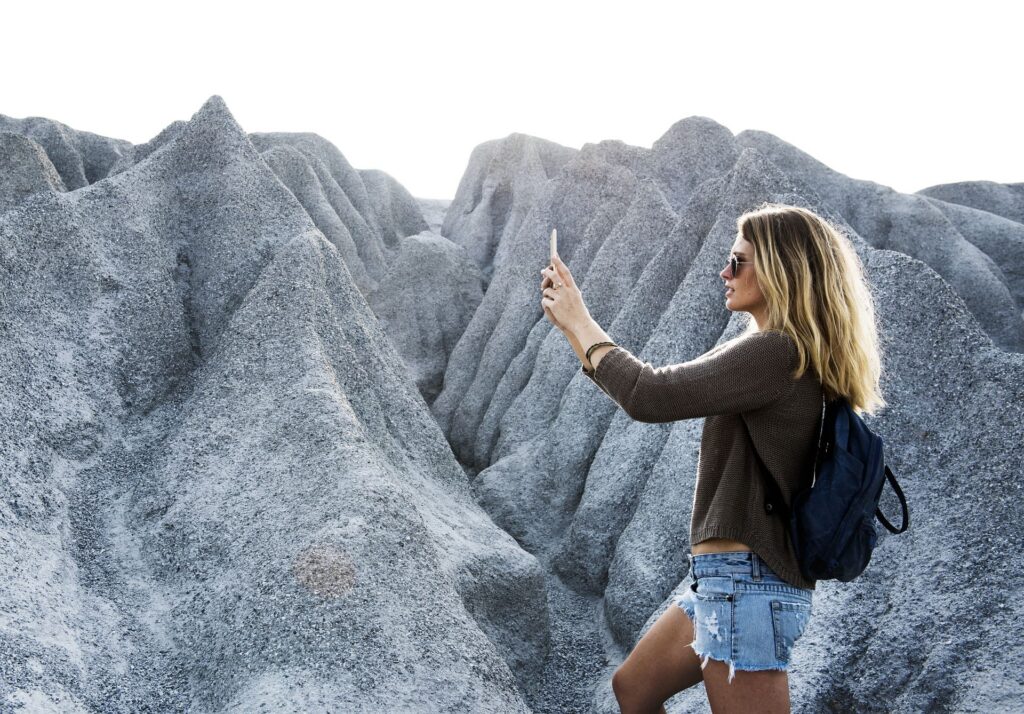 woman taking a selfie on top of a mountain