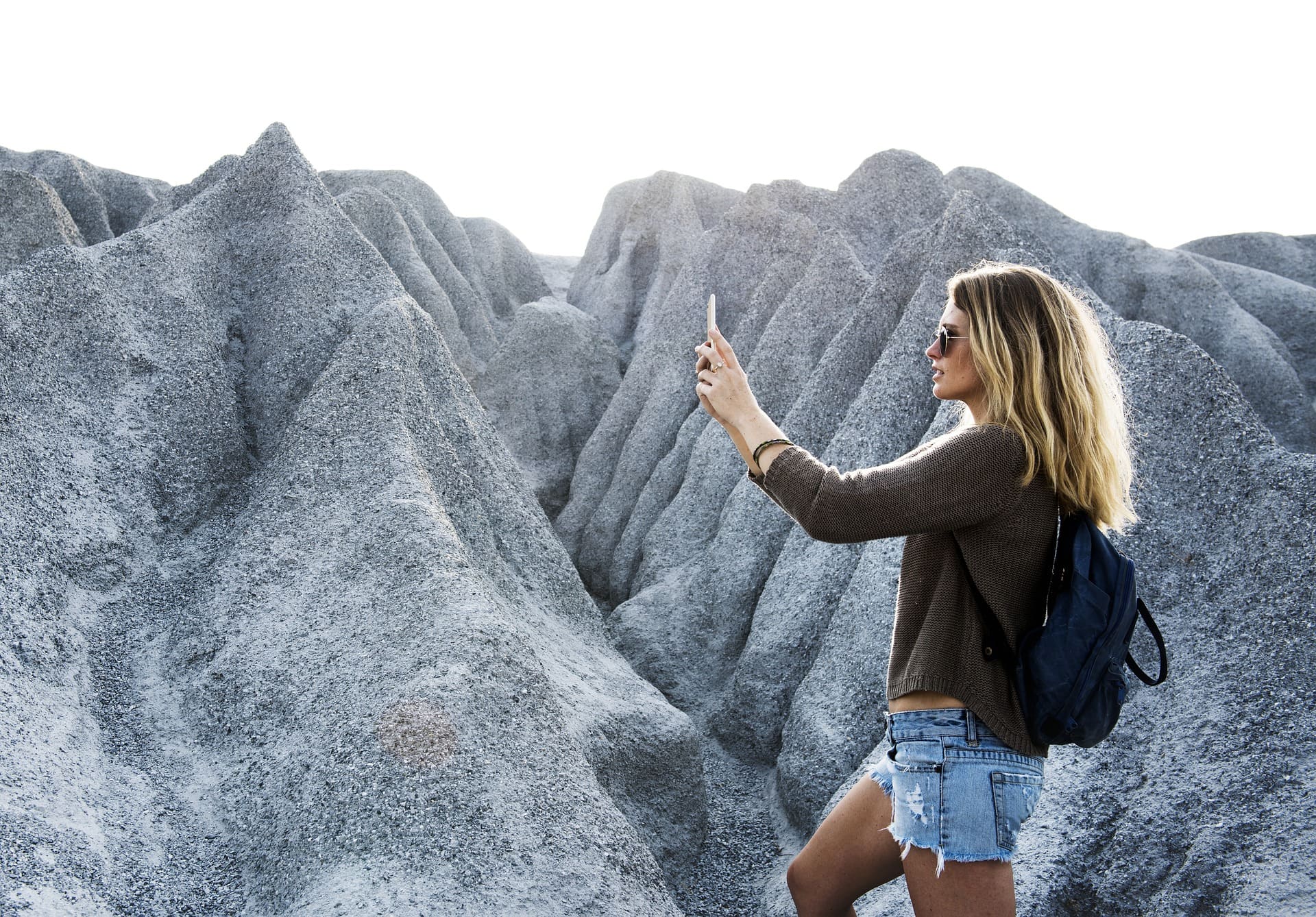 woman taking a selfie on top of a mountain