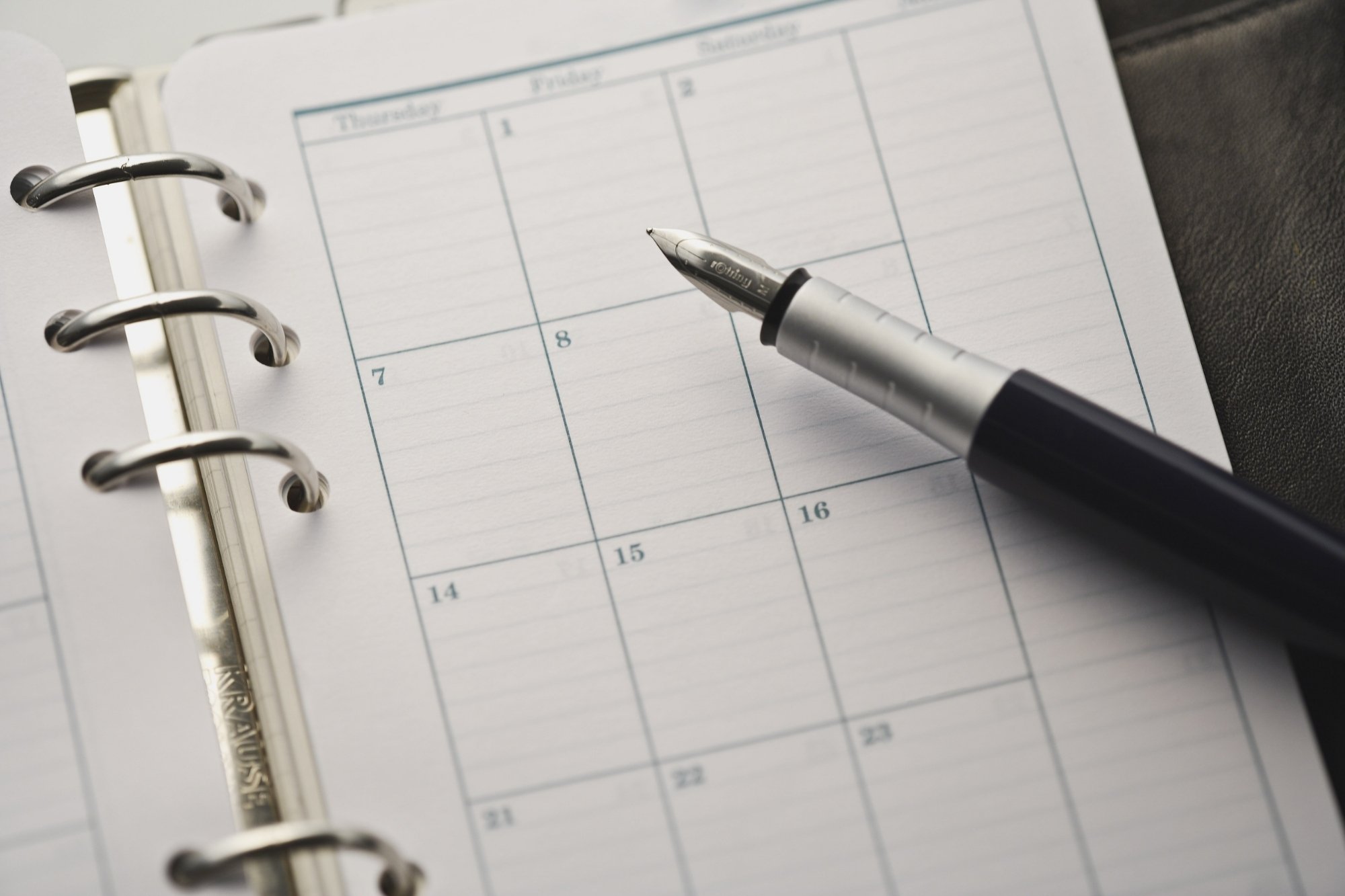 pen on top of a planner