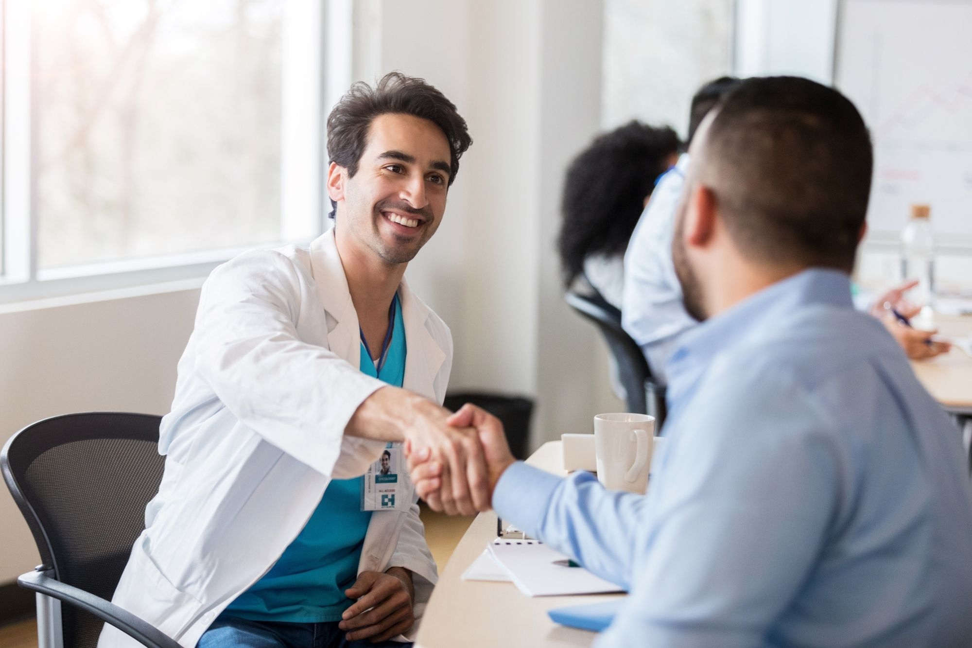 healthcare professional discussing phishing with cybersecurity agent