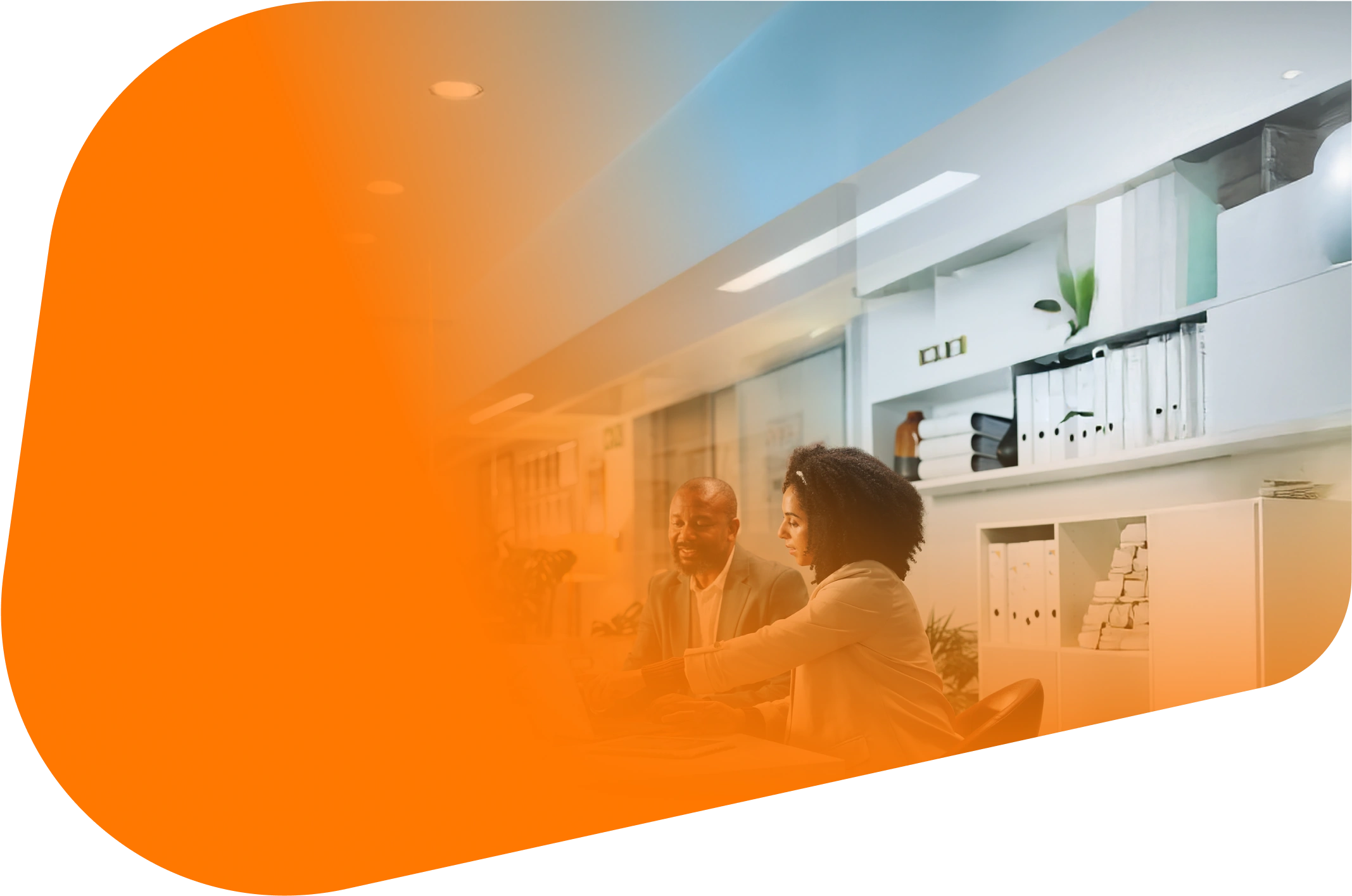 Two people sit together in a bright office. They look at a laptop and talk while an orange shape overlays the scene