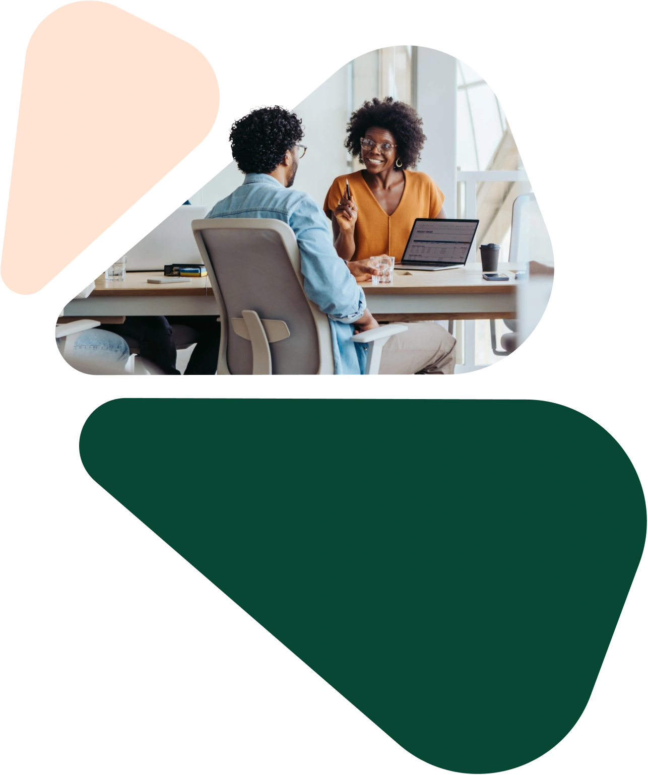 an-image-of-two-people-talking-at-a-desk-with-a-laptop