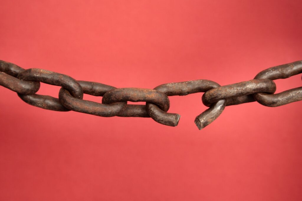 broken chain in red background