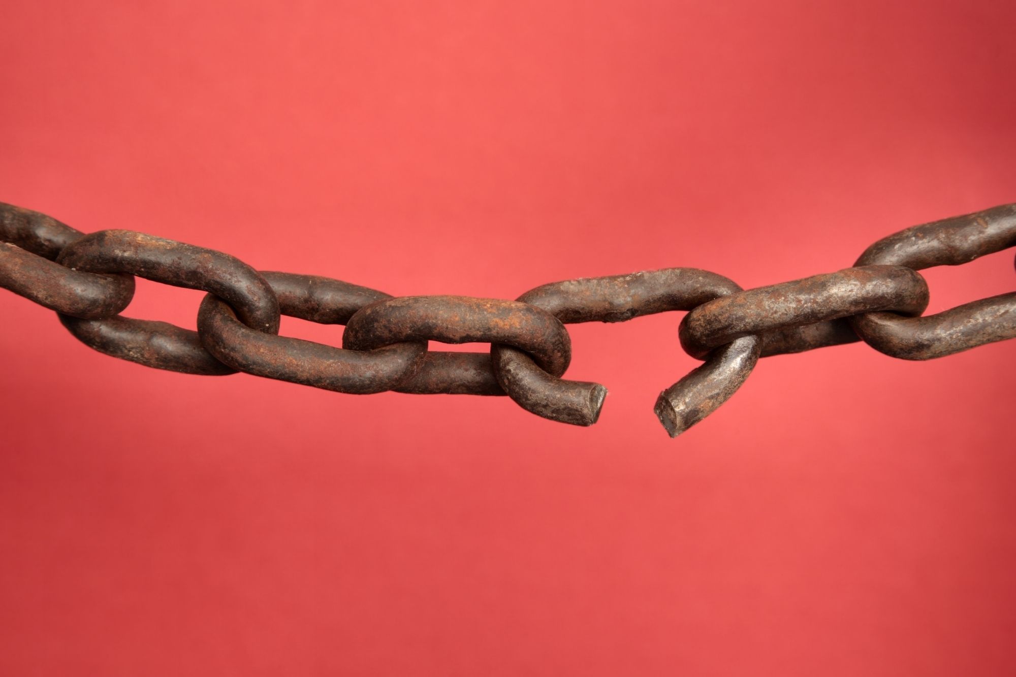 broken chain in red background