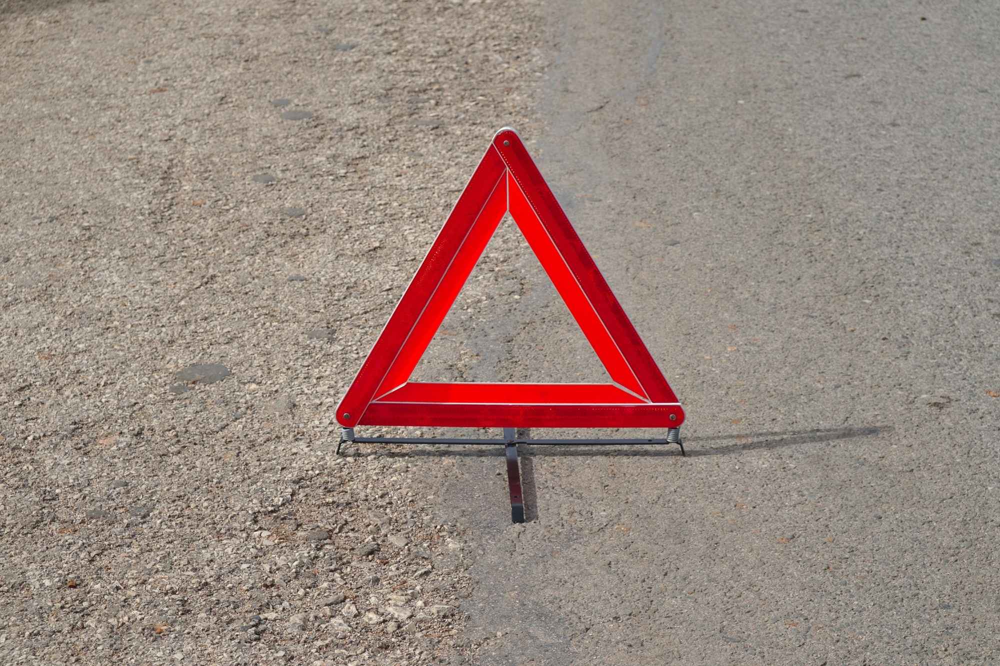 red triangle warning sign in the road