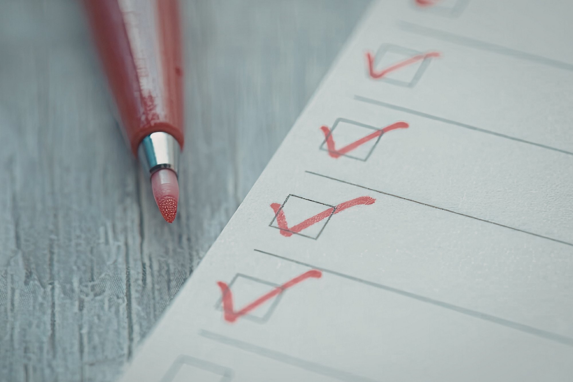checklist boxes being checked by red pen