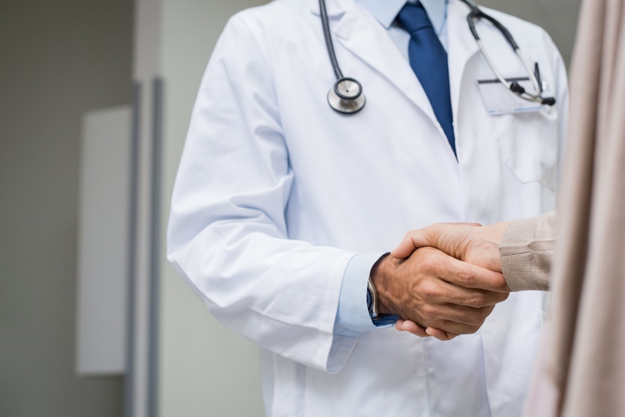 doctor and healthcare data partner handshaking