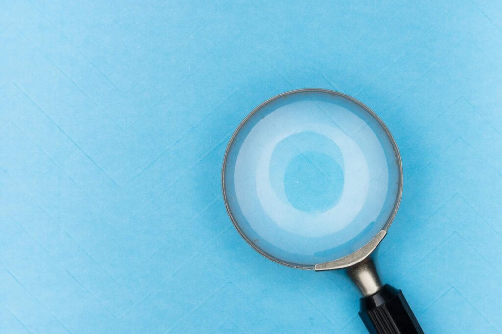 magnifying glass in sky blue background
