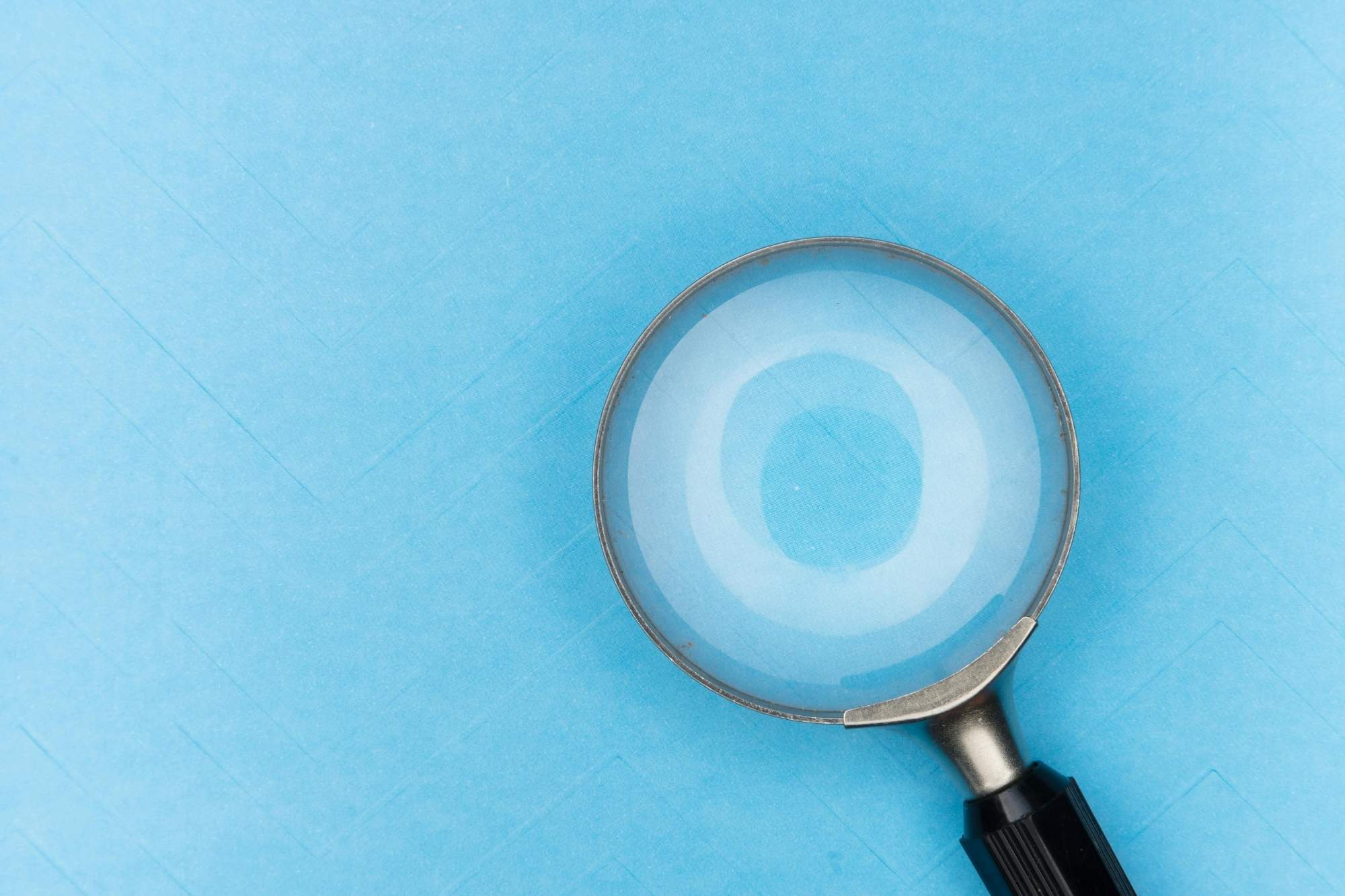 magnifying glass in sky blue background
