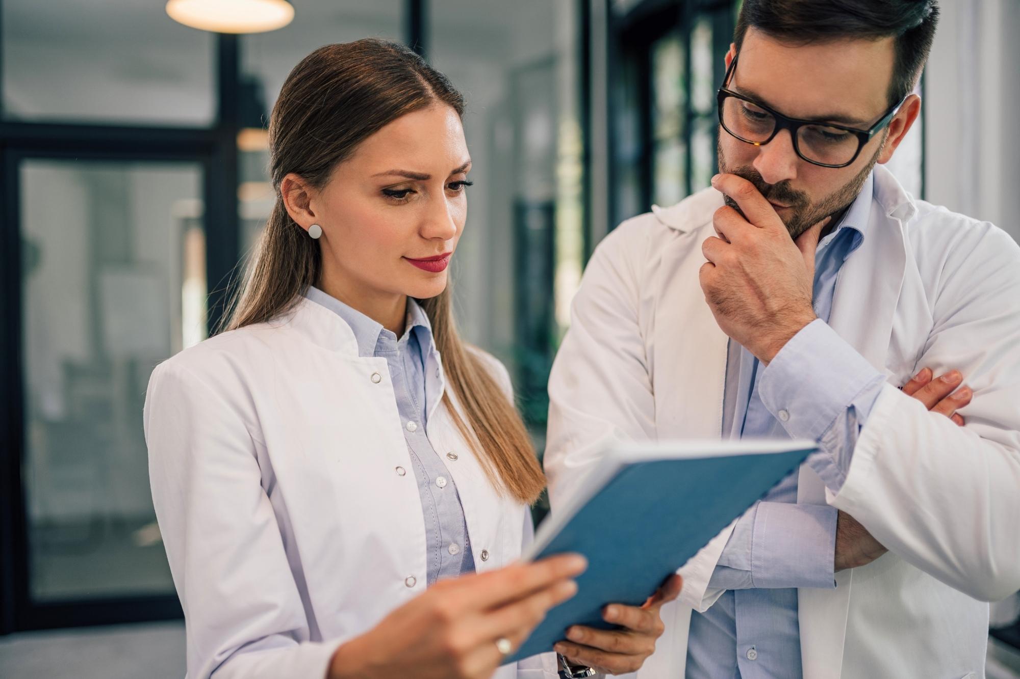 two doctors discussing ehr data problems