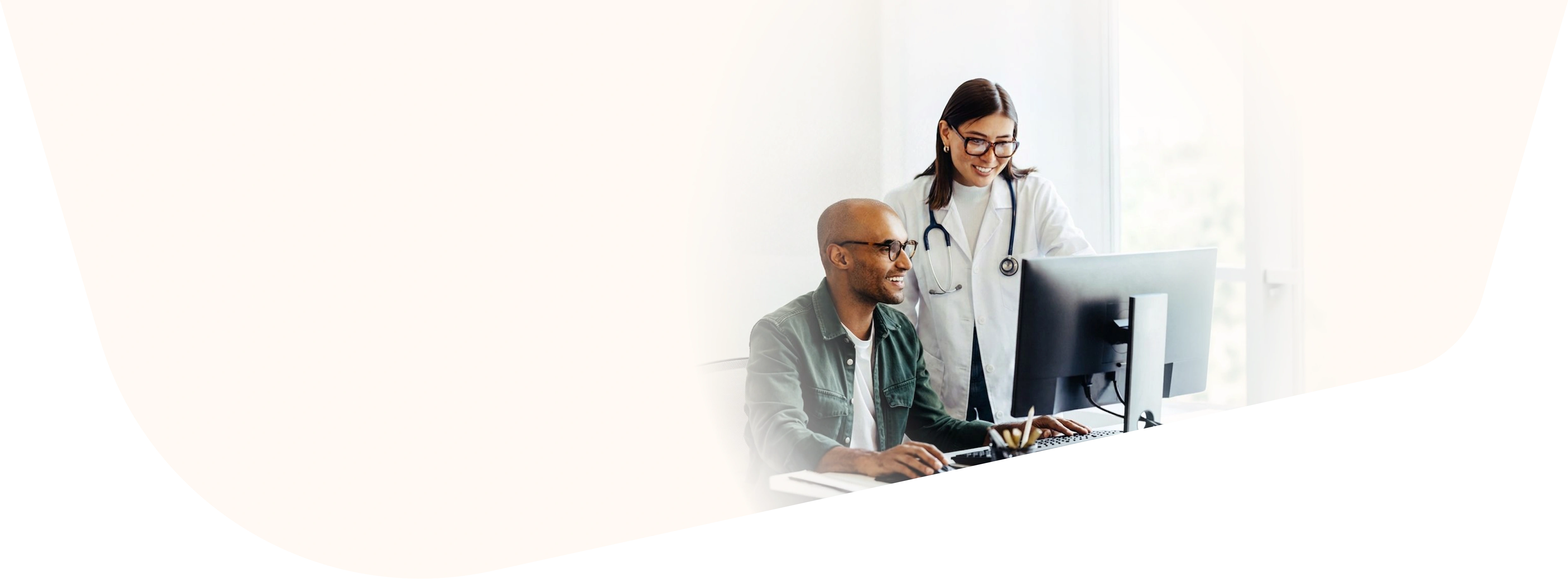 Doctor assisting a patient at a computer workstation
