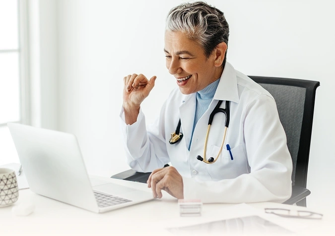 A doctor using a laptop