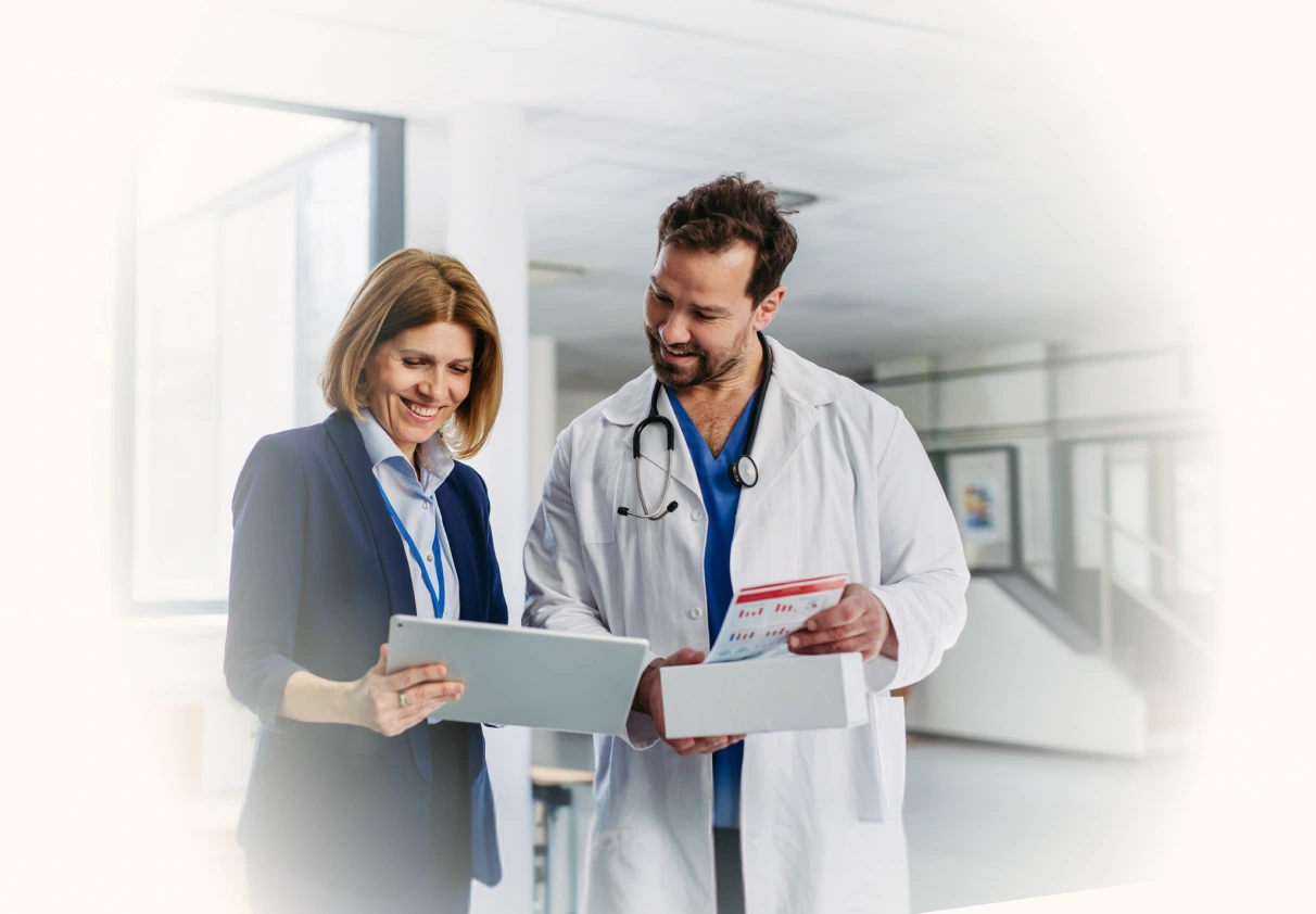 Doctor and healthcare administrator reviewing information on a tablet