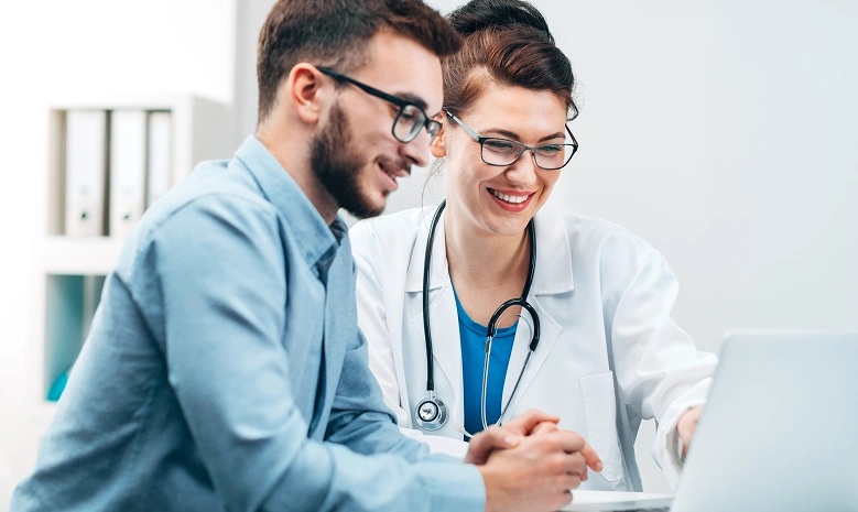 Doctor reviewing information on a laptop with a patient