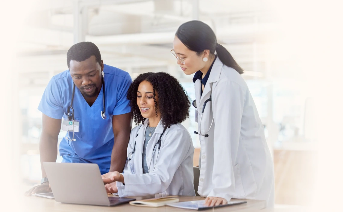 Medical team reviewing information on a laptop together