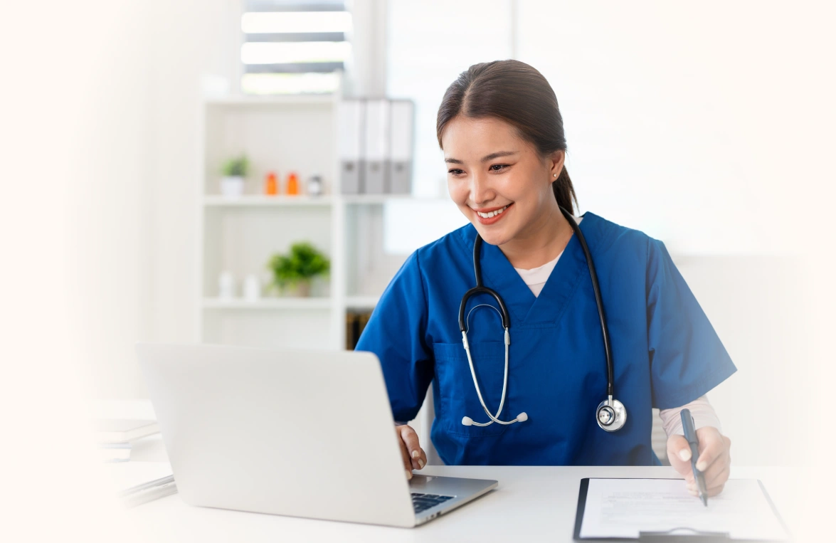 Senior middle aged medical worker in modern clinic wearing white doctor's gown coat using laptop writing health personal data, consulting remotely