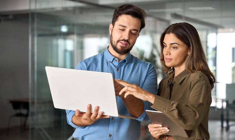 Two busy professional business people working in office with computer