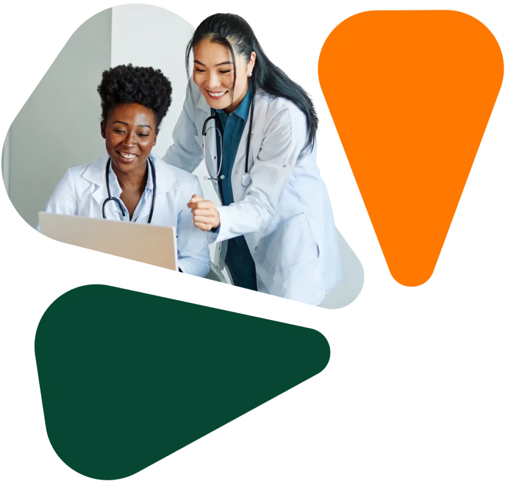 Two diverse female healthcare professionals collaborating at a computer