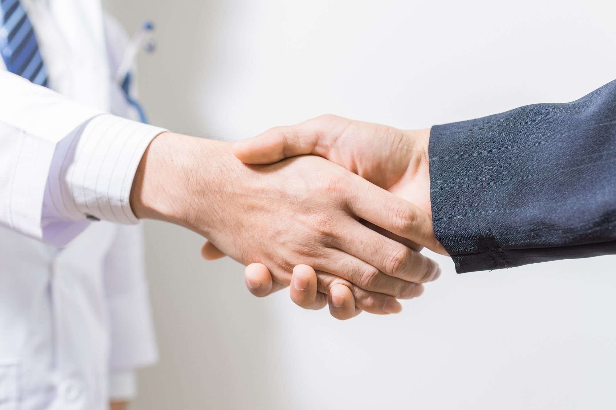doctor and it management provider shaking hands