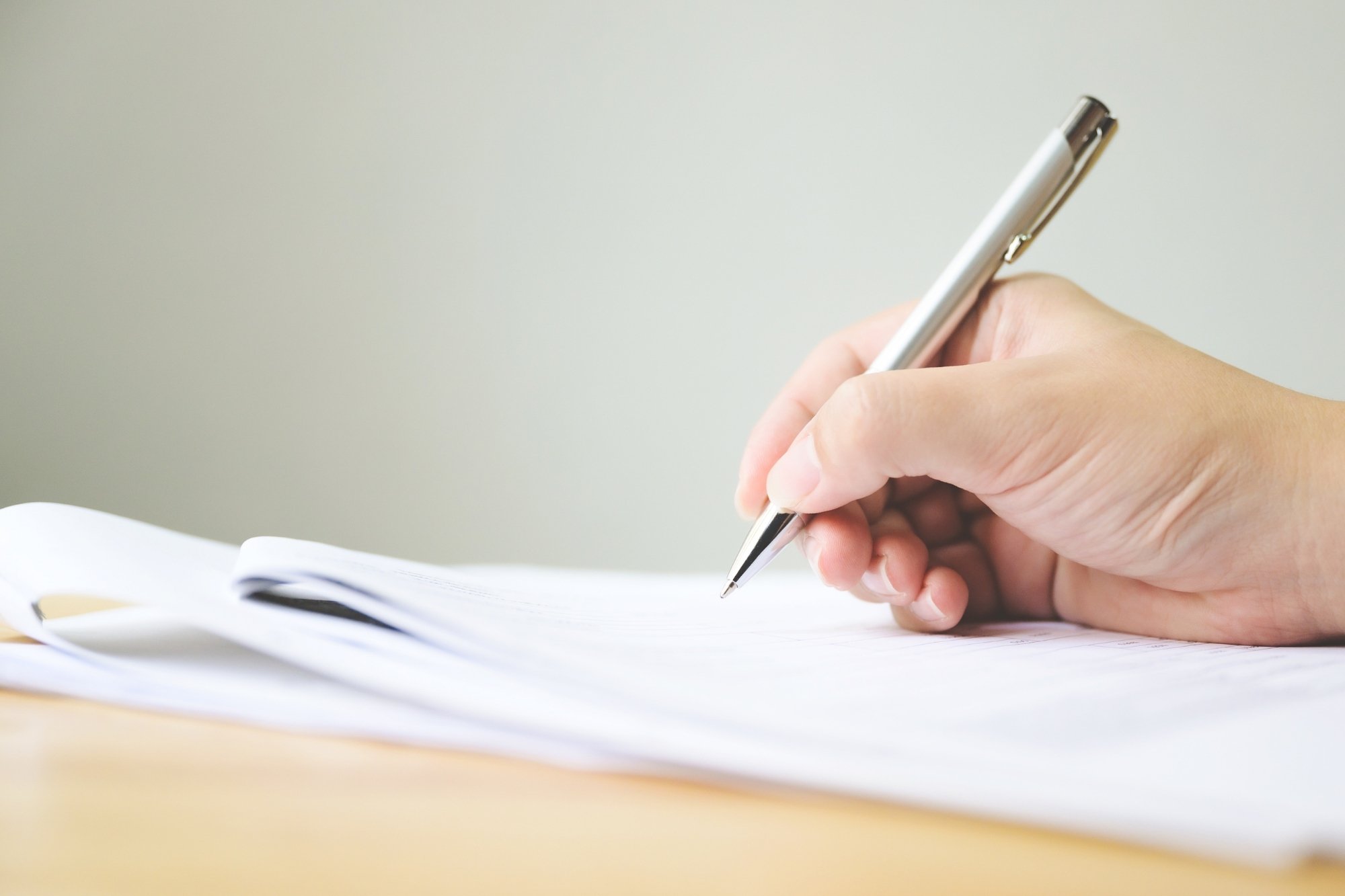 hand writing in a blank white paper