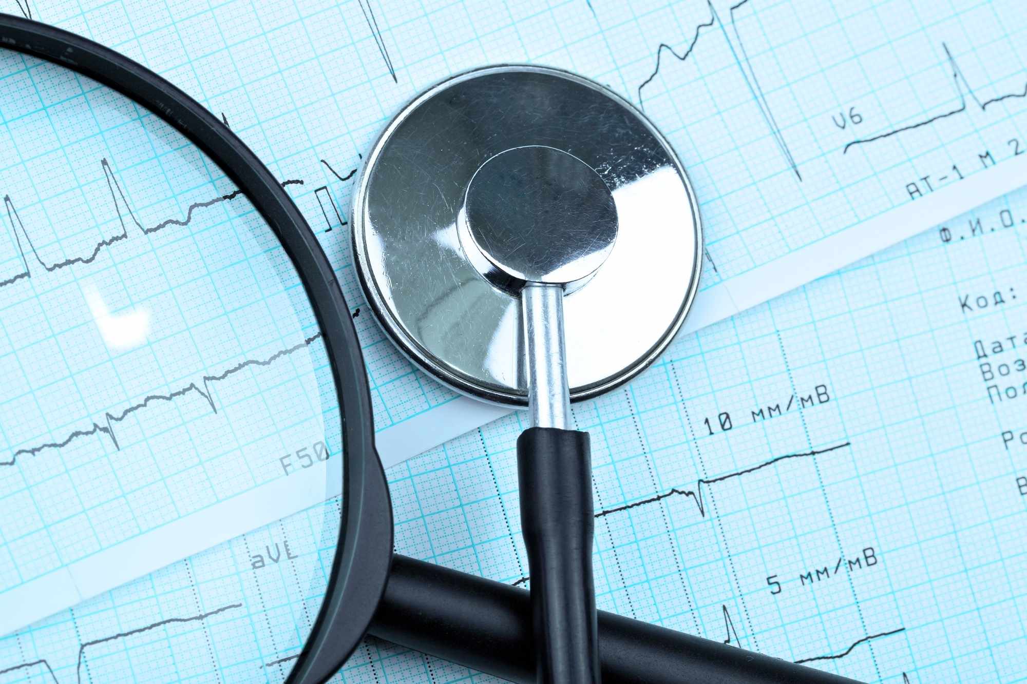 stethoscope magnifying glass and health charts