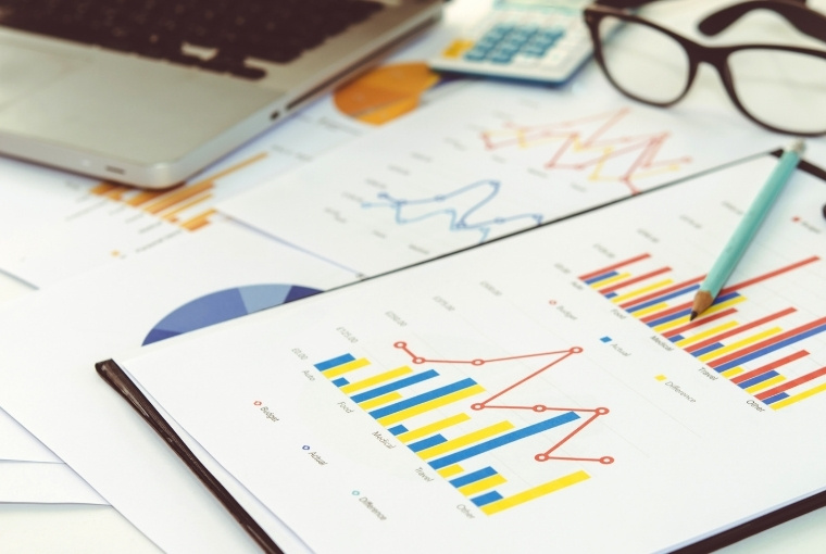 financial reports with colorful bar and line charts
