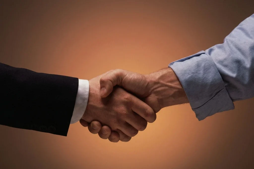 Handshake on orange background