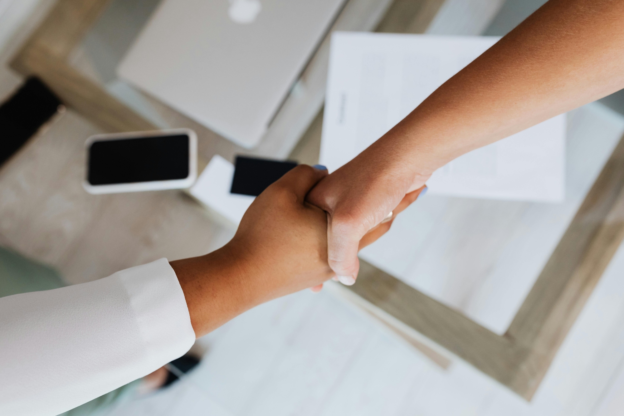 two network provider personnel shaking hands