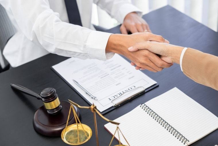 clinic owner handshaking to a it service provider after contract signing