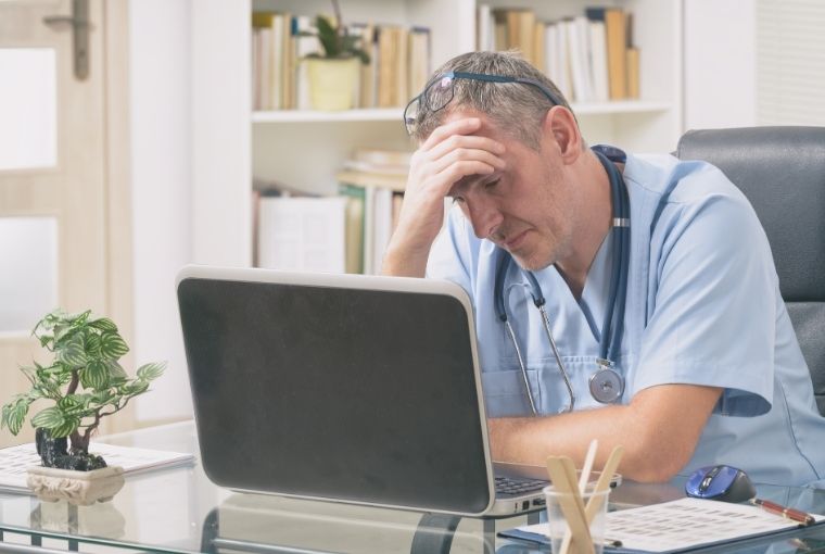 doctor worried while looking at his laptop