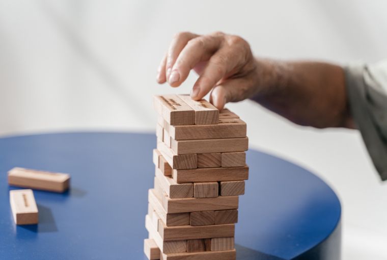 man stacking up wooden blocks