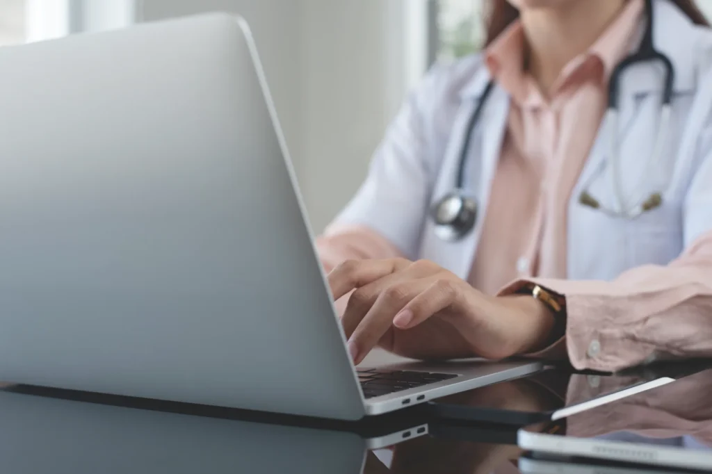 female doctor working on laptop computer at doctor's office